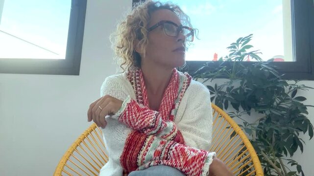 A 49-year-old woman patiently seated in the clinic's waiting room as she anticipates her scheduled consultation with a gynecologist to discuss treatment options for an extrauterine fibroid condition.