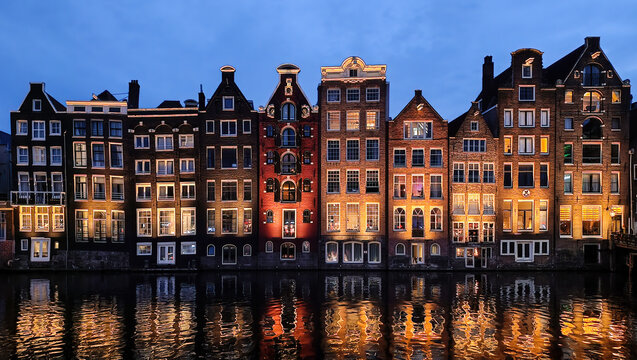 Dancing Houses of the Damrak in Amsterdam during the night. Netherlands Holland