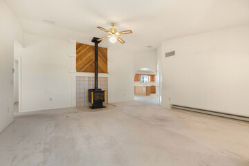 Spacious living room with wooden flooring and sliding doors leading to a bright outdoor area