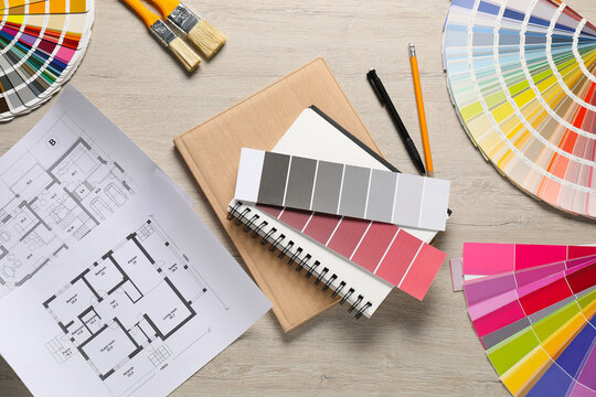 House plans and different decorator's tools on wooden table, flat lay