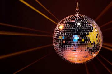 Disco ball reflecting light on dark background. Nightclub decor
