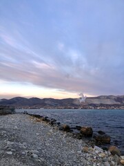 Evening view on the sea bay. Beautiful panorama of Novorossiysk city, Russia with ships and tankers in the port.