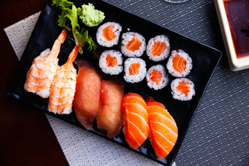 Various of nigiri and hosomaki sushi traditionally served with wasabi and soy sauce. Japanese cuisine