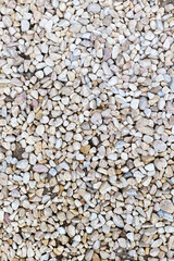 Natural pebble stone ground texture with mixed colors close-up