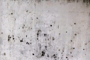 Grungy weathered concrete wall texture with black spots