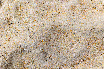 Close-up of fine sandy beach texture with tiny pebbles