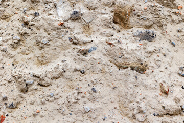 Rough sandy surface with rocks and debris in natural environment