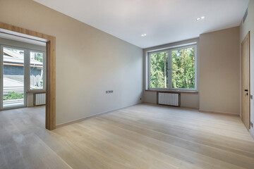 An empty room, decorated in pastel colors, in a private house. Unfurnished.