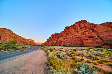 Red Rock Formations and Curving Road at Golden Hour in Utah Desert Scene