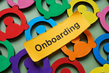 Multicolored employee figures and the word onboarding. Team integration.