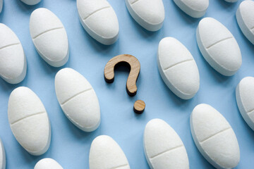 Medical pills and question mark. Side effects and health risks.