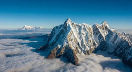 Fototapeta premium Mountain range with snow on the peaks and a blue sky