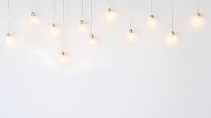 Illuminated Bulbs Hanging Against White Wall Background
