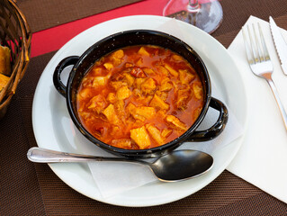 Appetizing hot tripe with chorizo and chickpeas served on plate