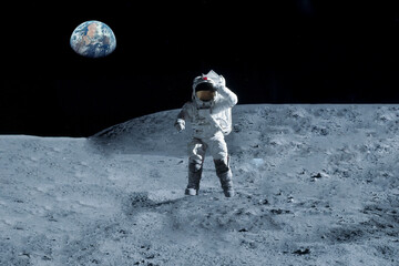 Astronaut is walking on the moon. With land on the horizon. Elements of this image were furnished by NASA. 