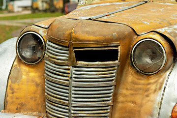 Fototapeta premium A rusty old car is parked in a parking lot