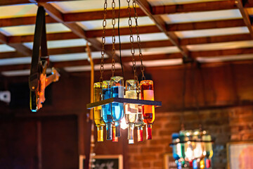 A chandelier made out of wine bottles hanging from a ceiling