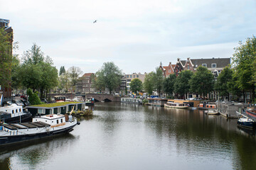 Colorful buildings on the Waalseilandsgracht canal with boats. Amsterdam, Netherlands