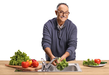 Man washing vegetables for a salad