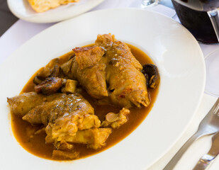 Delicious stewed pork knuckles and mushrooms - traditional Catalonian dish