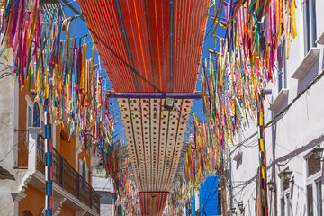 Colorful cloth banners hanging over a street in San Juan La Laguna, Guatemala. © Emily_M_Wilson