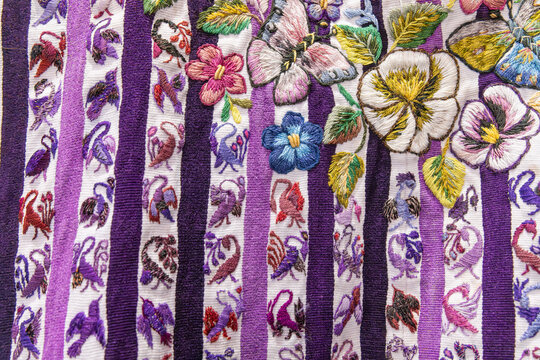 Traditional embroidered cloth with patterns of birds and flowers.