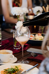Pouring sparkling wine into a glass, perfect for elegant dining and celebration moments