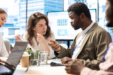 Obraz premium Forecast affiliates using infographics reports on files to review the progress, collaborating to increase sales for business development. Team presents data driven insights to general manager.