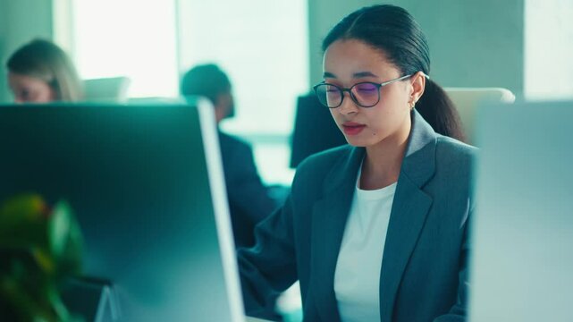 Professional Woman Typing in a Bright Modern Office