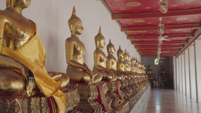 Bangkok, Thailand - A row of golden Buddha statues in the Wat Pho complex. Wat Pho is one of Bangkok's oldest temples.