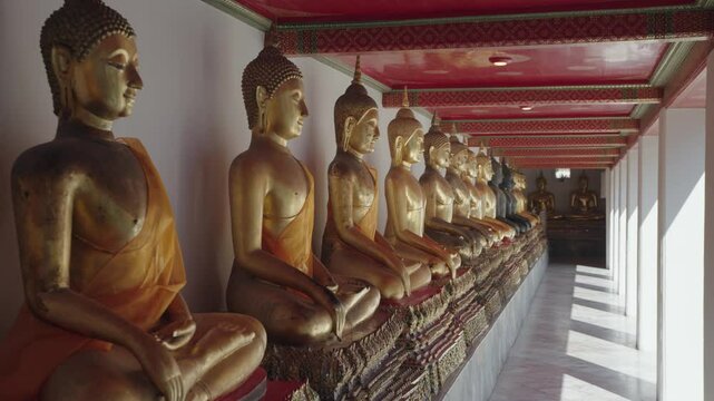 Bangkok, Thailand - A row of golden Buddha statues in the Wat Pho complex. Wat Pho is one of Bangkok's oldest temples.
