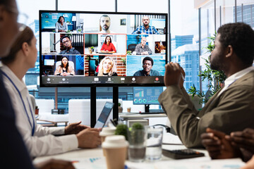 Diverse team of workers reviewing project updates together with shareholders on video call online meeting, ensuring easy remote collaboration for global business expansion plans. Teamwork.