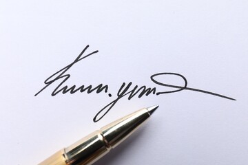 Pen and signature on white paper, closeup