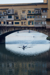 Rower under the bridge in Florence, Italy © Brue