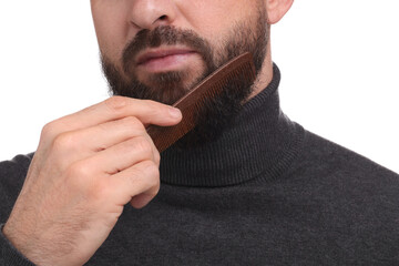Fototapeta premium Man combing beard on white background, closeup