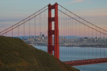 The sun sets on the Golden Gate Bridge at the mouth of the San Francisco Bay