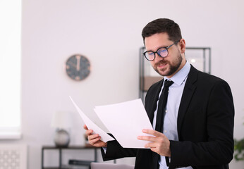 Portrait of banker with documents in office, space for text