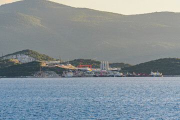Fototapeta premium Early Construction Phase of Peljesac Bridge in Southern Croatia at Sunset with Scenic Mountain Backdrop