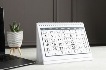 Timetable. Calendar, laptop and floral decor on white table
