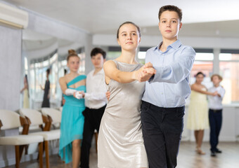 Boy and girl dance couples ballroom dance waltz in studio