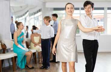 Fototapeta premium Couple boy and girl rehearsing waltz dance in studio