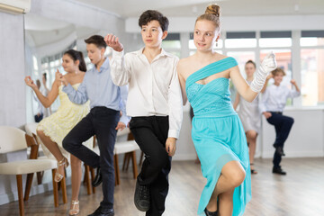 Fototapeta premium Boy and girl dance energetic twist dance in studio