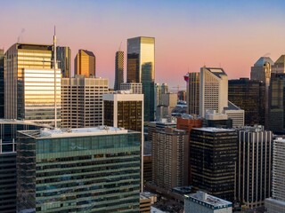 Calgary skyline at twilight, showcasing modern office buildings and the iconic Calgary Tower. Urban landscape. Eau Claire, Calgary, Alberta, Canada