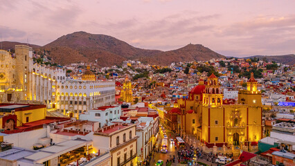 Aerial photo of the city of Guanajuato during the early evening hours. The lights of its emblematic...