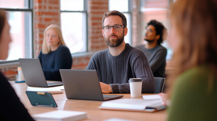 Obraz premium Sunlit Loft Office Collaboration with Coworkers Around Table