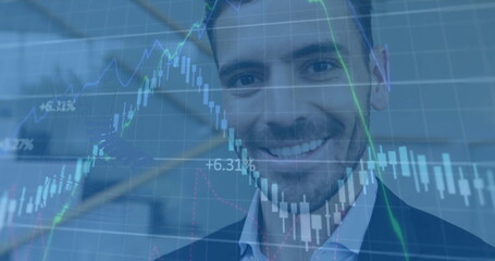 Image of chart and data processing over happy caucasian bsuinessman using smartphone