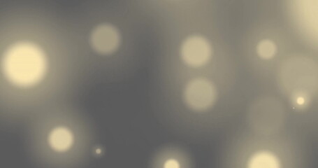 Image of glowing light spots over grey background