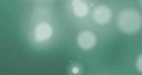 Image of glowing light spots over green background