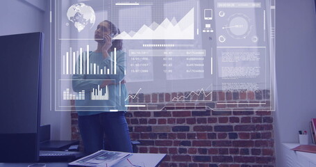 Image of financial data processing over biracial businesswoman in office