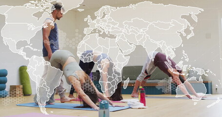 Image of world map and processing data over diverse male instructor and female yoga class
